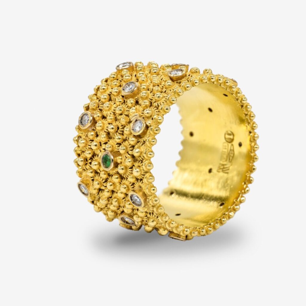 Gold ring with gemstone details.