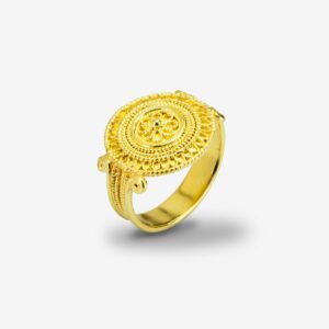 Ornate gold ring with intricate circular design.