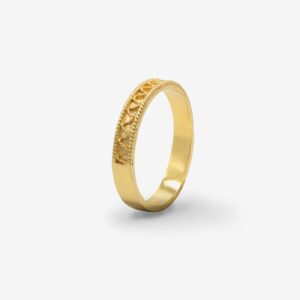 Gold ring with intricate design pattern.
