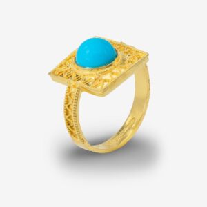 Gold ring with turquoise stone, intricate design.