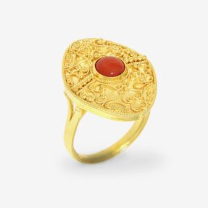 Gold ring with intricate design and gemstone.